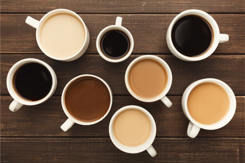 Different Types Of Coffee In Cups On Wooden Table P47K9NH 1