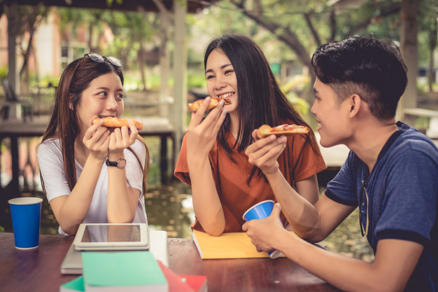 Young Asian People Celebrating With Pizza Hand Food Friendship Concept Lifestyles Theme_10307 437