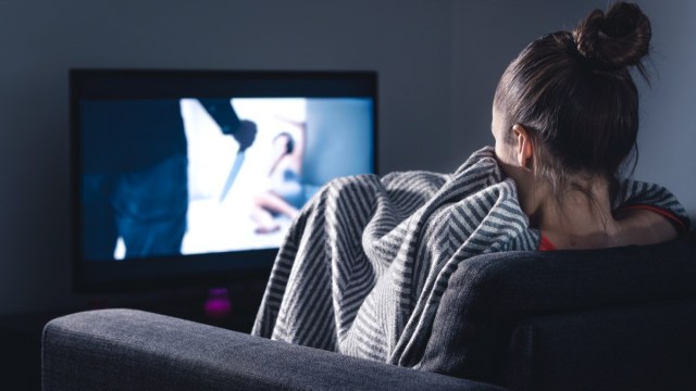 Young Woman Watching Scary Movie