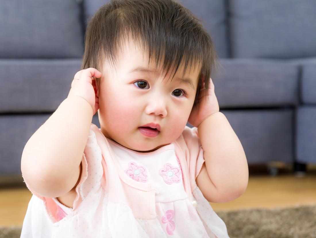 Baby Girl With Both Hands Holding Ears