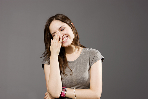 Girl Laughing With Hand On Face