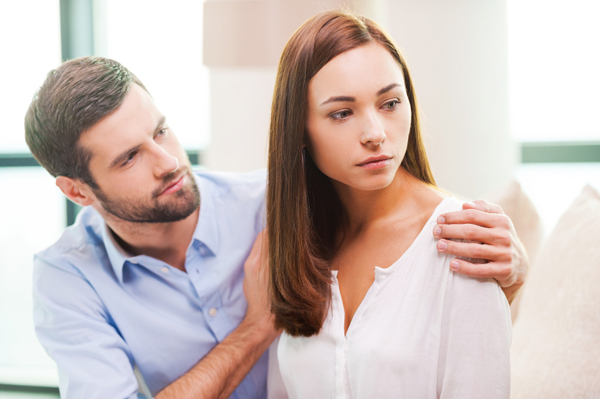 Consoling His Depressed Girlfriend. Depressed Young Woman Lookin