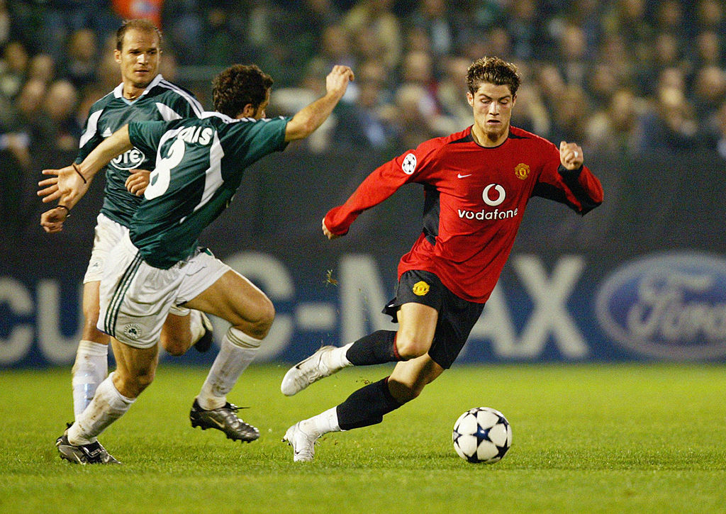 Ioannis Goumas Of Panathinaikos Chases Cristiano Ronaldo Of Manchester United