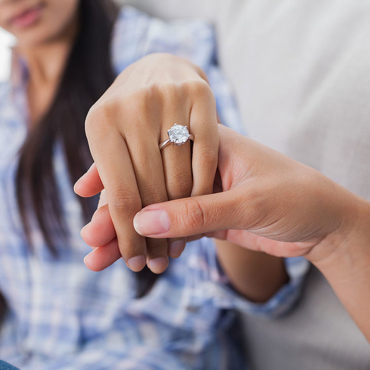 Engagement Ring On Womans Hand Held By Her Friend