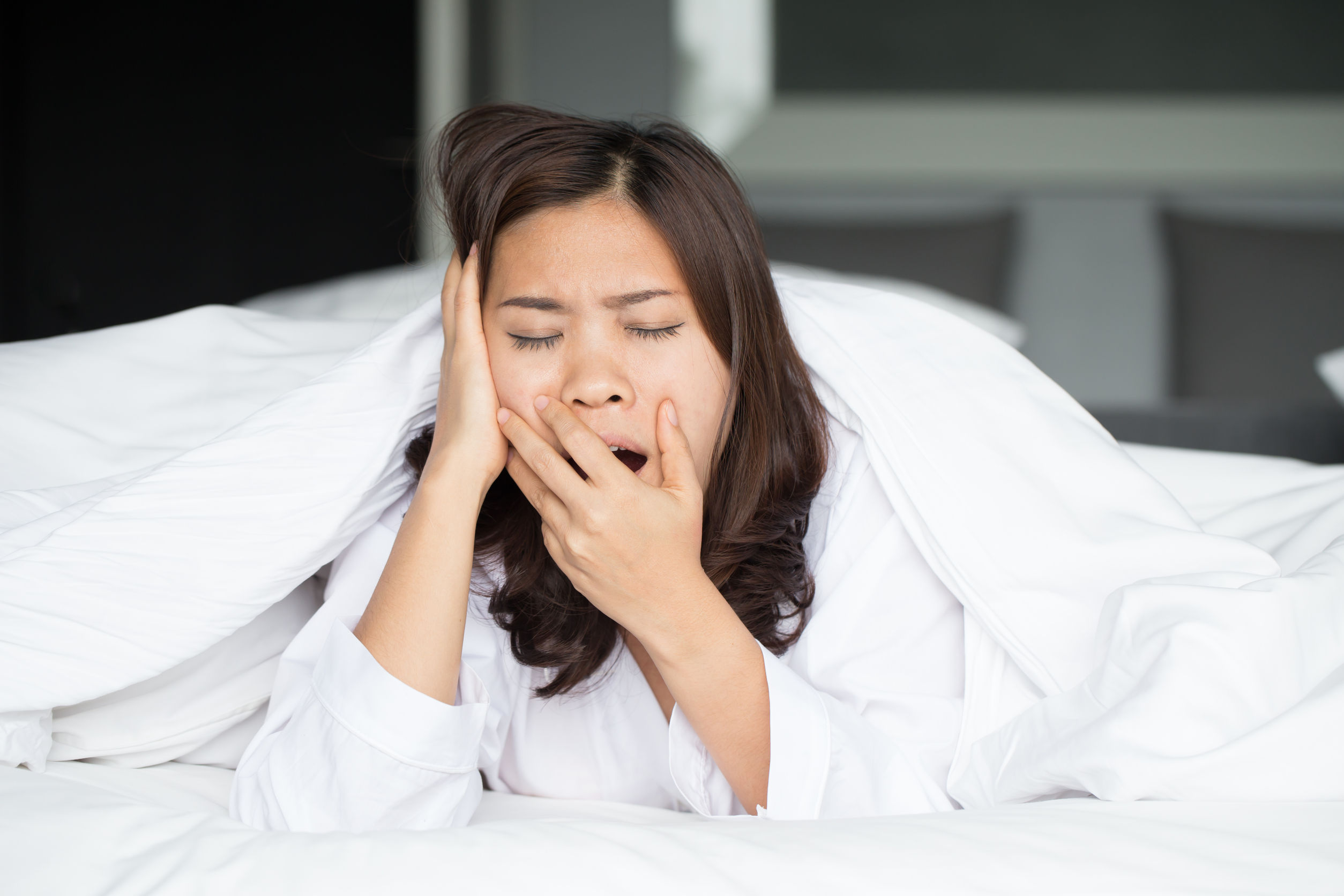 39062171 Sleepy Asian Woman Yawning In Bed At Home