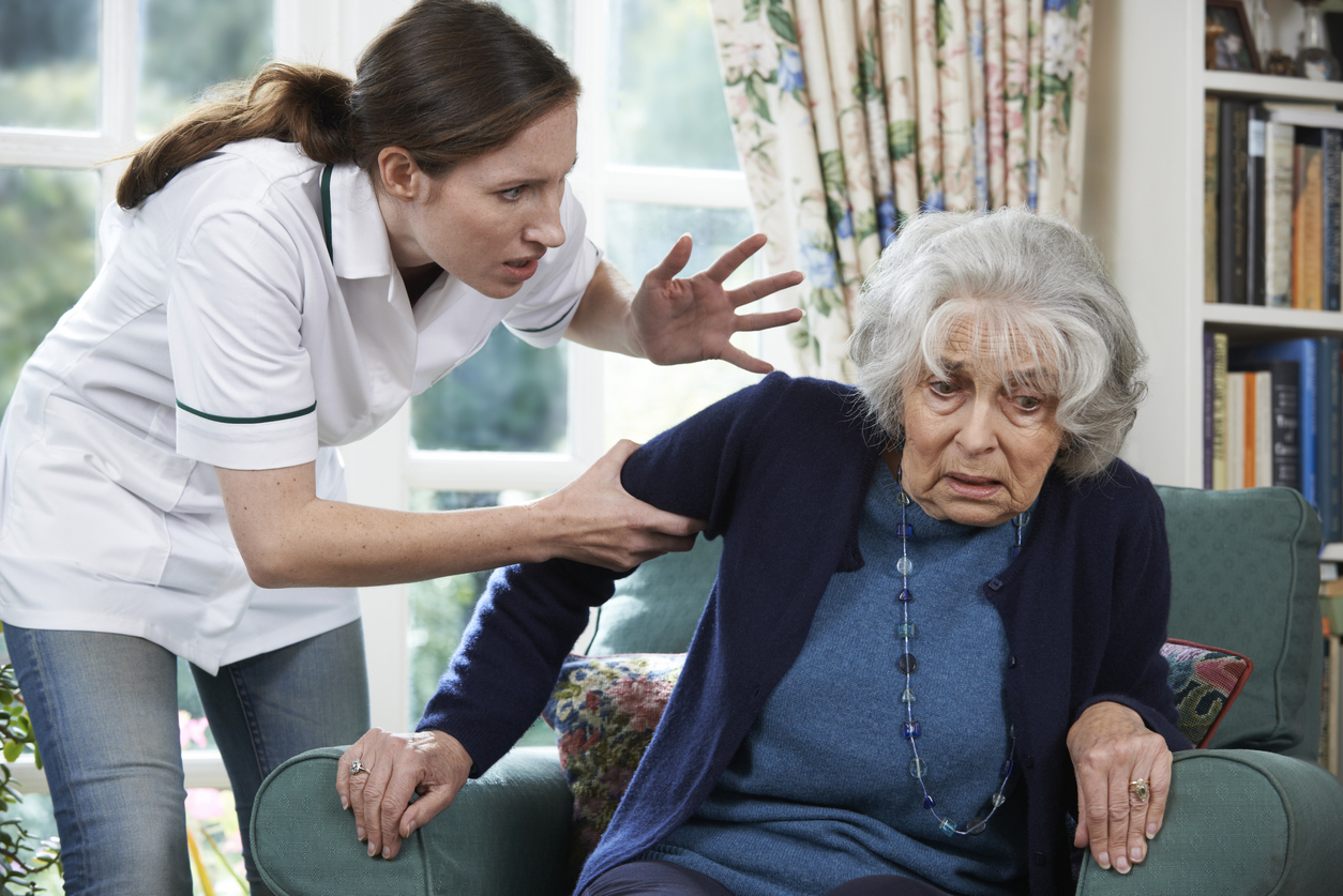 Care Worker Mistreating Senior Woman At Home