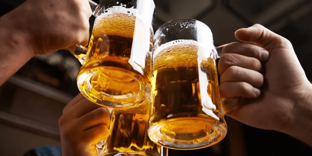 Hands Of Three Men Doing A Beer Toast 1024x512