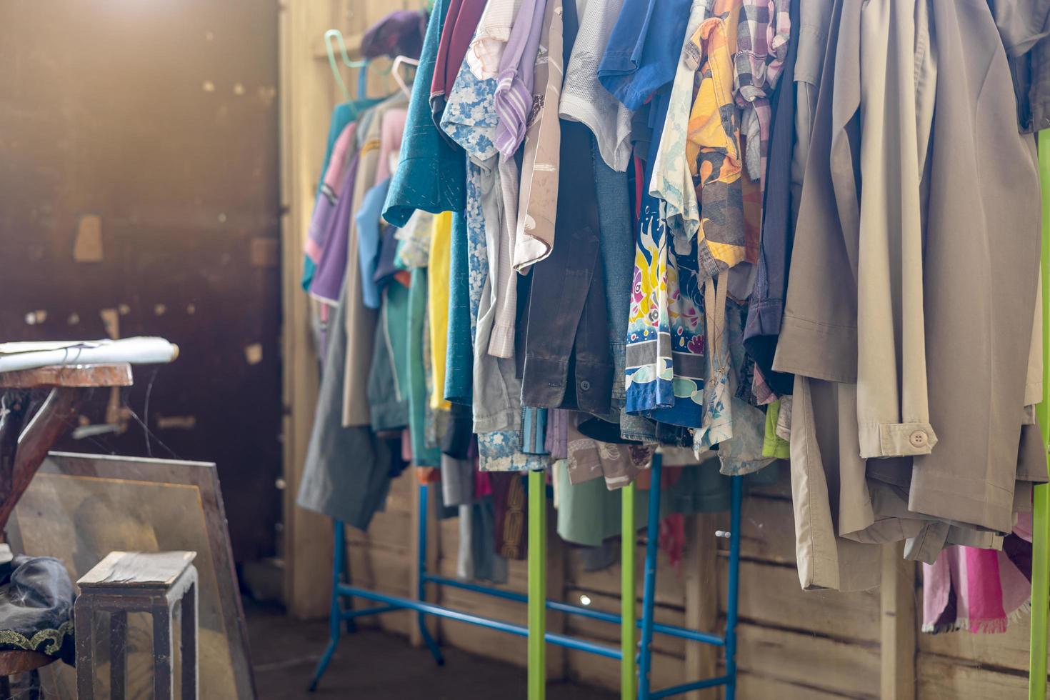 Colorful Old Clothes Are Hanging Disorderly On Iron Railings Near The Cluttered Things Free Photo